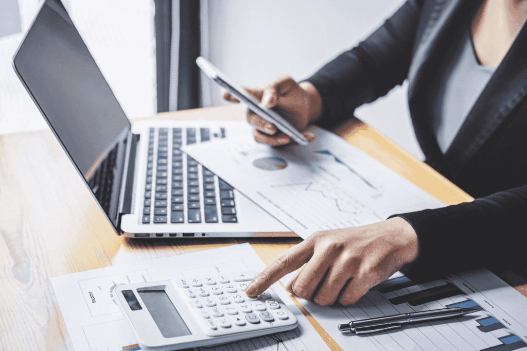 A businesswoman analysing and calculating financial graphs