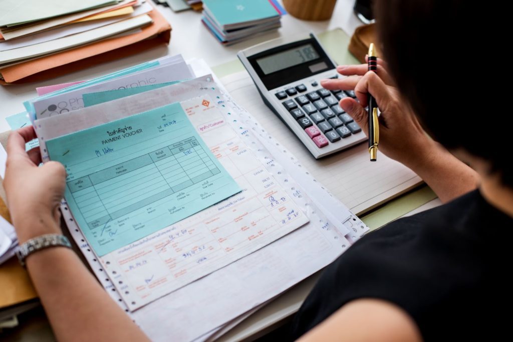A woman working through paperwork