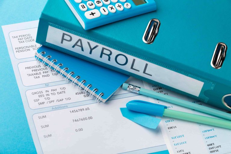 Payroll file and pens on a table