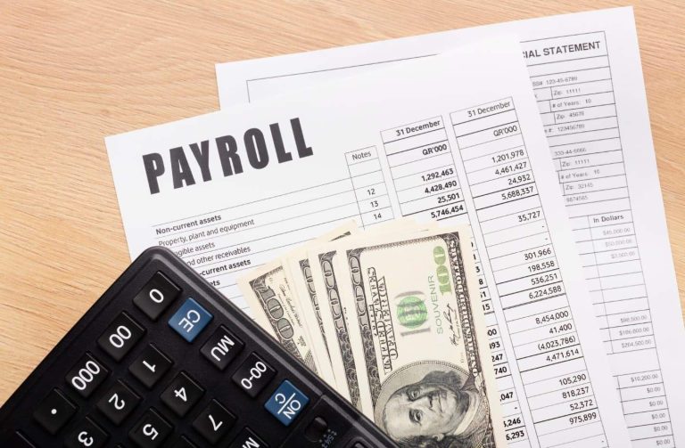 Payroll documents, cash and calculator on a table
