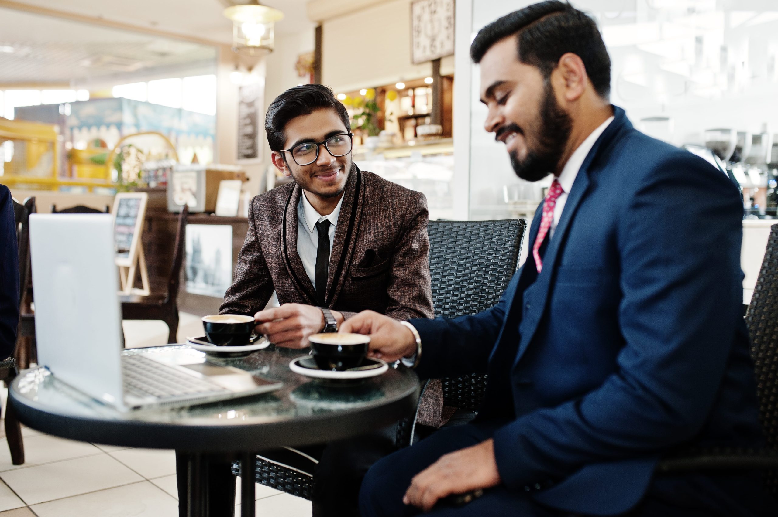 two businessman sitting in office pitching deck