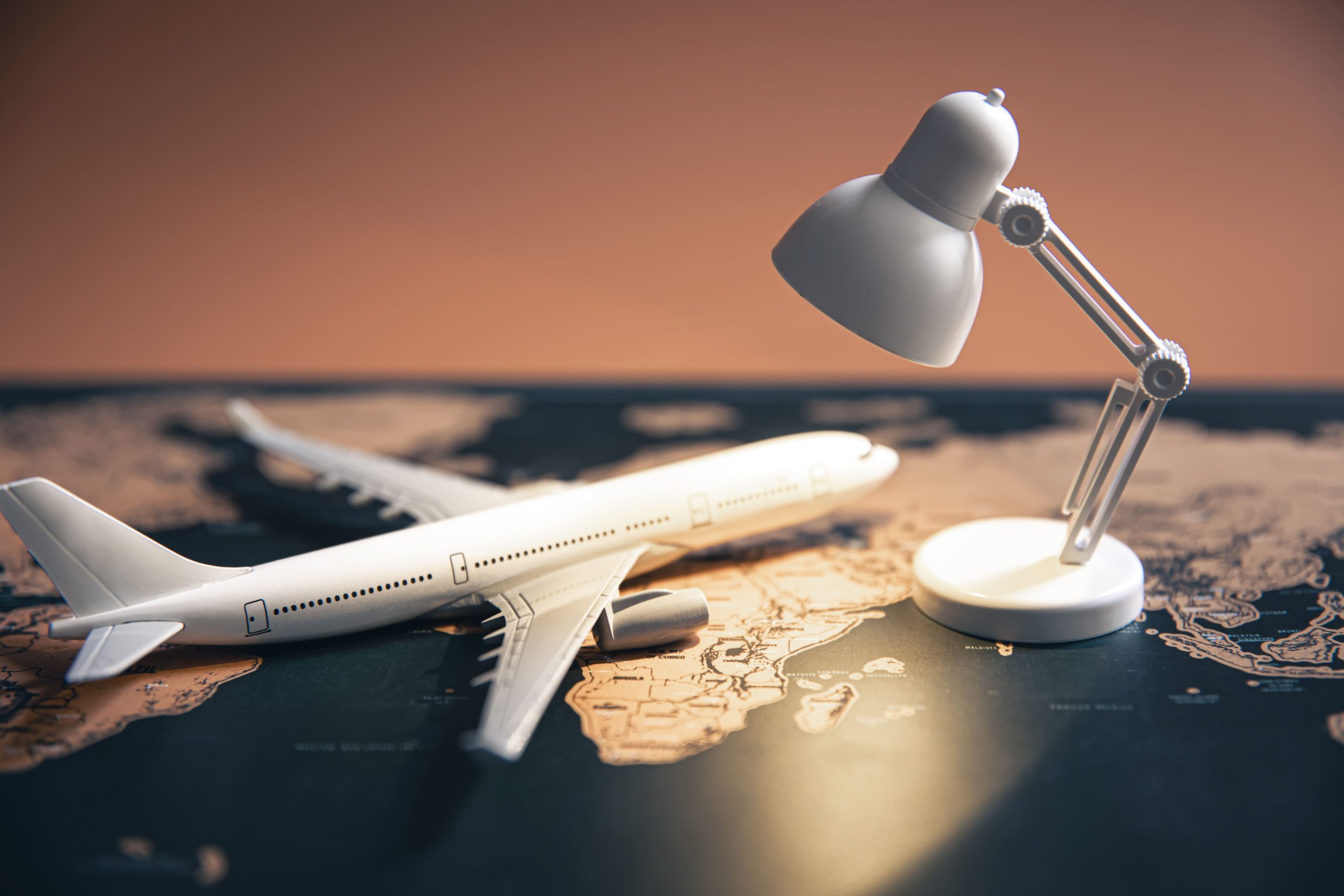 small table lamp with a toy plan over a world map